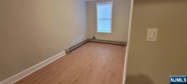 829 Willow Avenue, Unit 3 Hoboken, NJ 07030 - Photo 5 of 16 a view of a room with wooden floor and a window