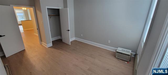 829 Willow Avenue, Unit 3 Hoboken, NJ 07030 - Photo 8 of 16 an empty room with wooden floor and windows