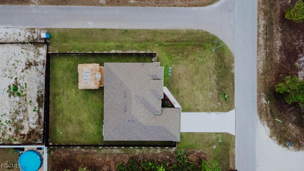 2819 34th Street West Lehigh Acres, FL 33971 - Photo 11 of 41 an aerial view of a house with a yard