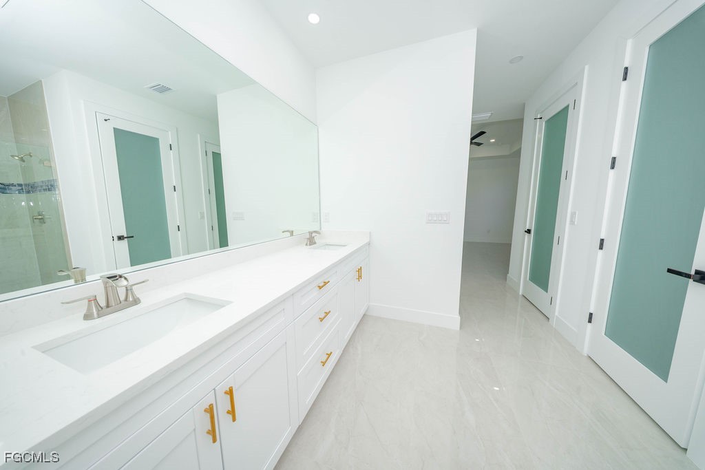 2819 34th Street West Lehigh Acres, FL 33971 - Photo 14 of 41 a spacious bathroom with a double vanity sink mirror and double