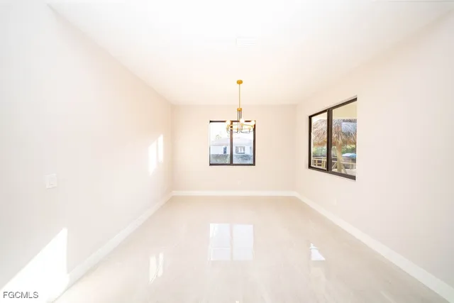 a view of a room with a ceiling fan and window