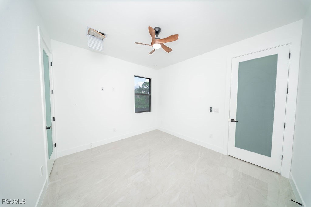 2819 34th Street West Lehigh Acres, FL 33971 - Photo 22 of 41 a view of a room with a ceiling fan and window