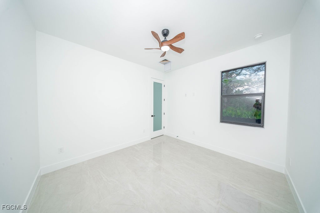 2819 34th Street West Lehigh Acres, FL 33971 - Photo 24 of 41 an empty room with a window and a ceiling fan