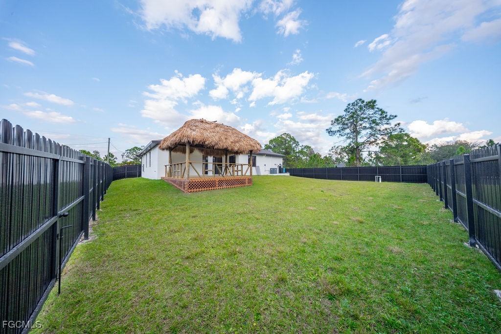 2819 34th Street West Lehigh Acres, FL 33971 - Photo 27 of 41 a view of a house with backyard and a garden