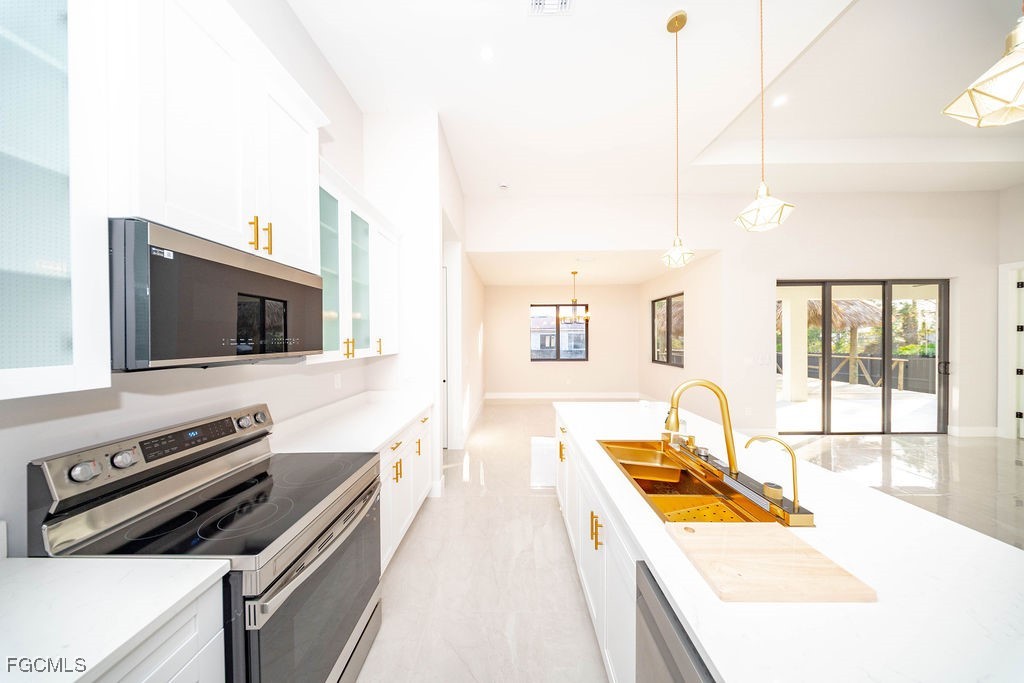 2819 34th Street West Lehigh Acres, FL 33971 - Photo 3 of 41 a living room with furniture and a flat screen tv
