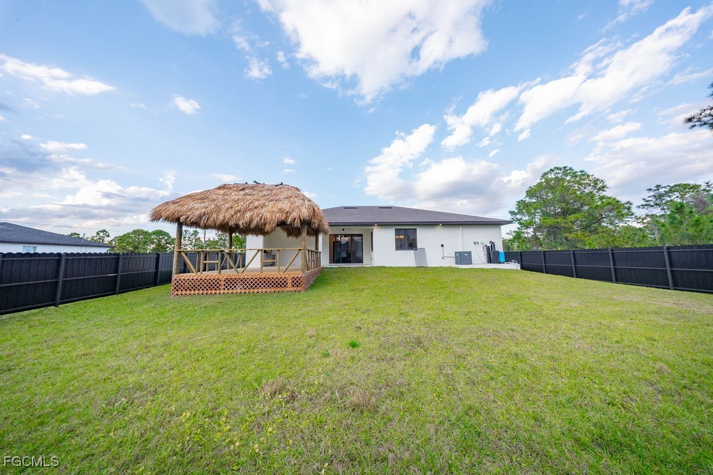 2819 34th Street West Lehigh Acres, FL 33971 - Photo 33 of 41 a view of a house with a yard and sitting area