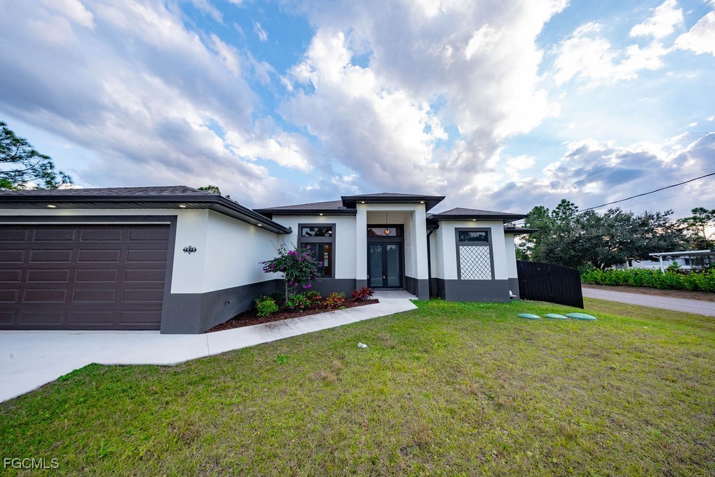 2819 34th Street West Lehigh Acres, FL 33971 - Photo 34 of 41 a view of a yard in front of house
