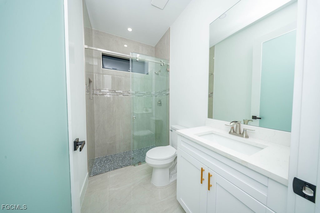 2819 34th Street West Lehigh Acres, FL 33971 - Photo 8 of 41 a bathroom with a sink a toilet and shower