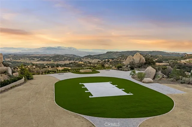 an aerial view of a house with a garden and trees