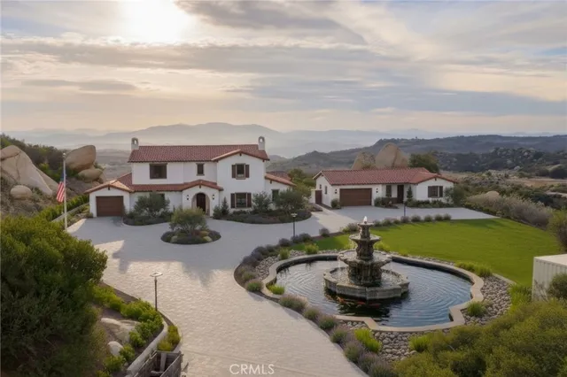 a view of a house with swimming pool and a yard