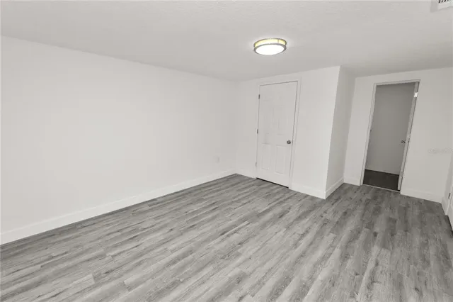 a view of a room with wooden floor