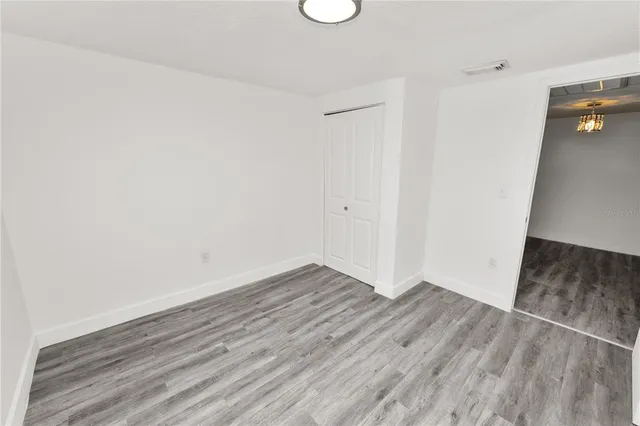 an empty room with wooden floor