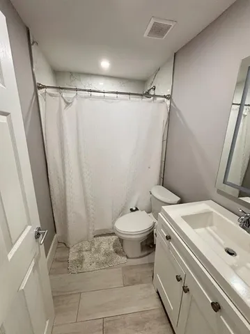 a bathroom with a sink toilet and shower