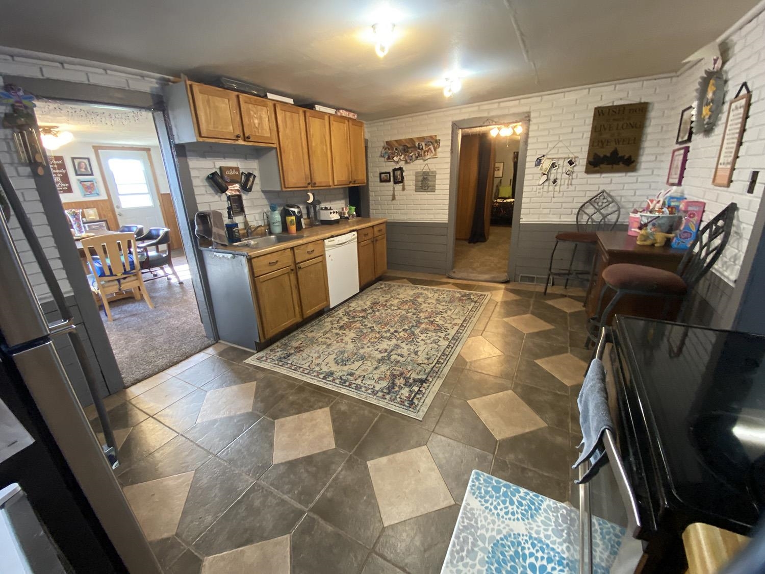 6510 Water Road Lanark, IL 61046 - Photo 12 of 38 a kitchen with stainless steel appliances kitchen island granite countertop a refrigerator and a stove top oven