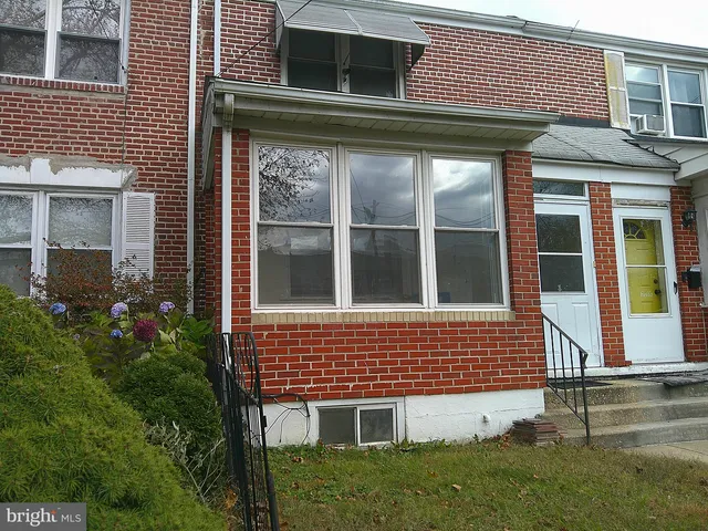 a view of brick house with a large windows