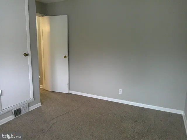 an empty room with closet and door