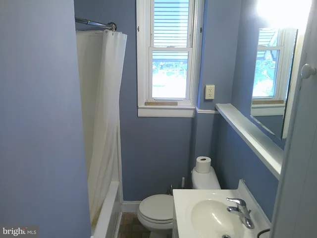 a bathroom with a toilet and a sink