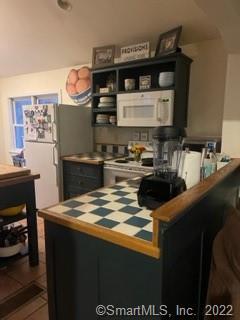 22 Horseshoe Road Wilton, CT 06897 - Photo 15 of 24 a kitchen with granite countertop a sink stove and cabinets