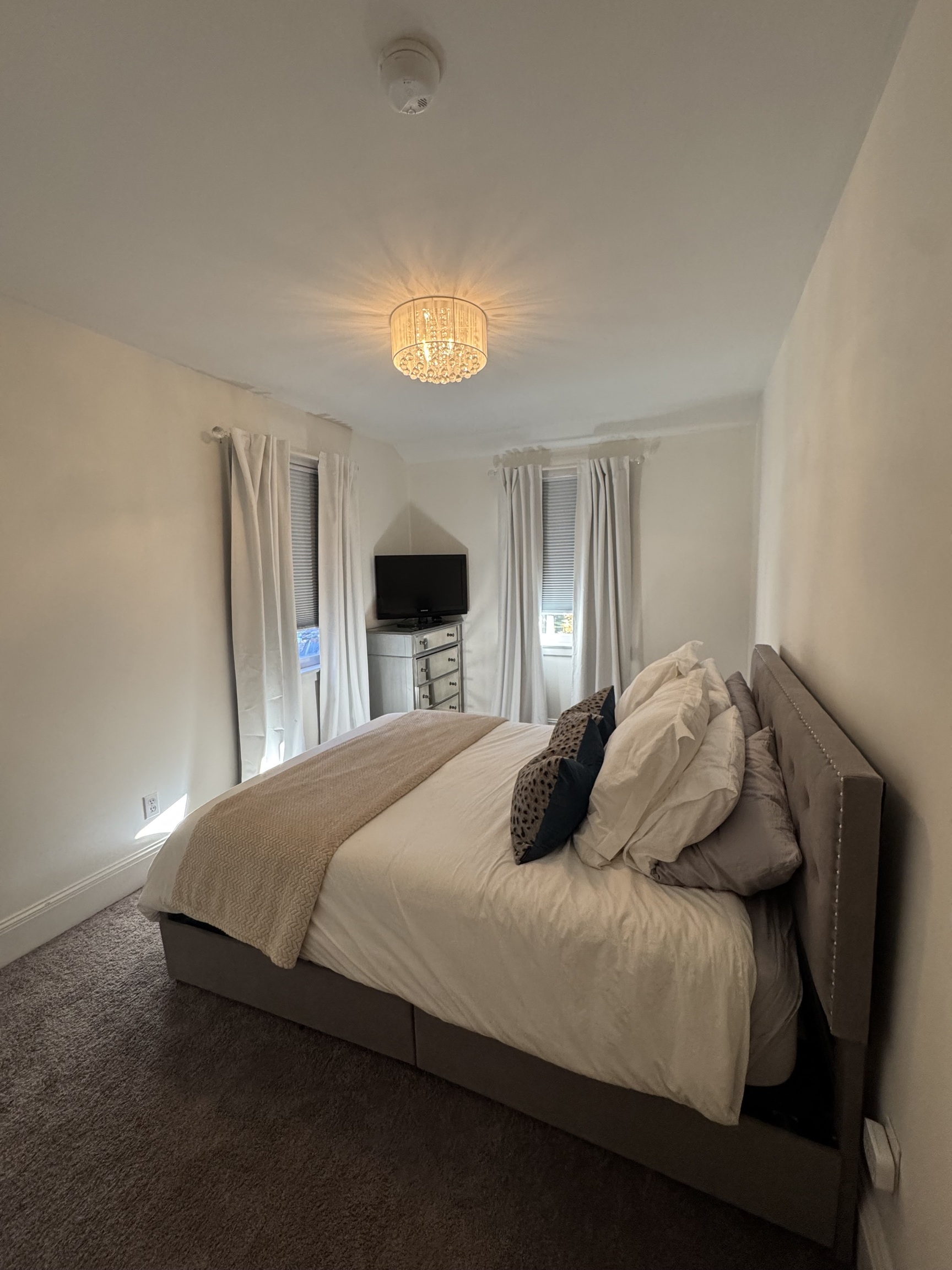 22 Horseshoe Road Wilton, CT 06897 - Photo 24 of 24 a bedroom with a bed and a chandelier