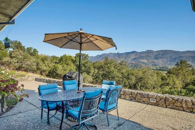 a view of balcony with furniture and umbrella