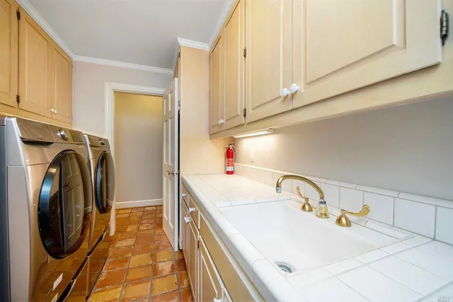 a bathroom with washing machine and sink