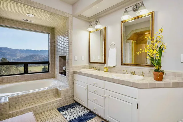 a bathroom with a double vanity sink and a bathtub