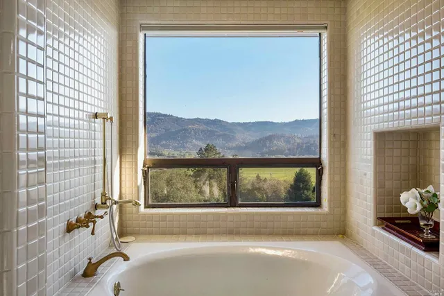 a bathroom with a bathtub and window