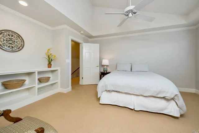 a spacious bedroom with a bed and cabinets