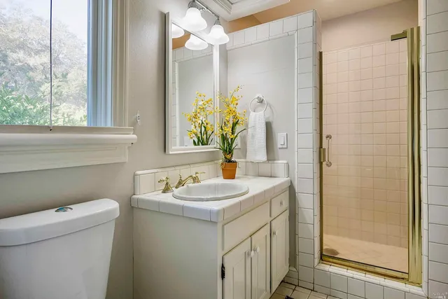 a bedroom with a bed and a lamp on desk