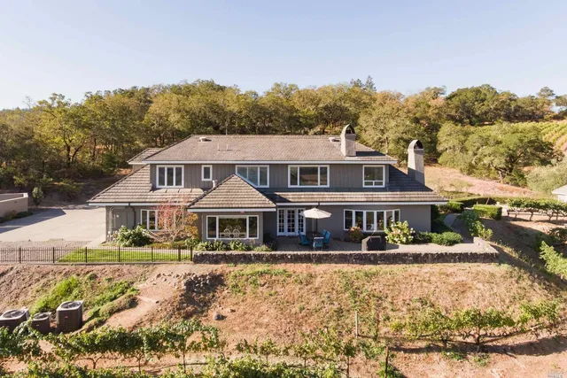 a view of a swimming pool with a lounge chair and a small yard