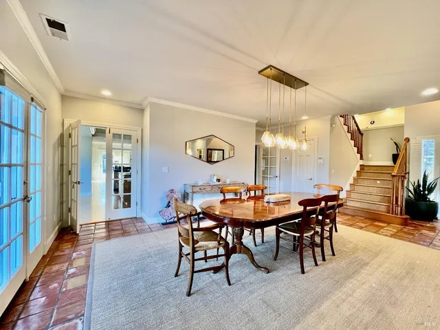 a dining room with furniture and wooden floor