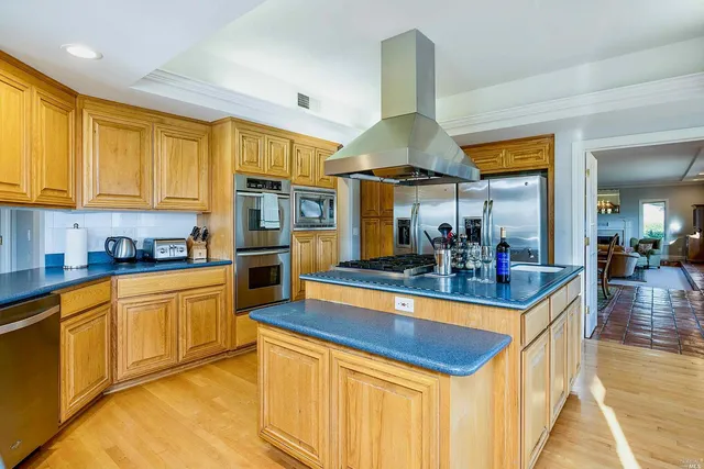 a kitchen with stainless steel appliances granite countertop a sink and cabinets