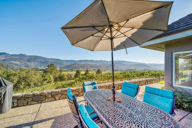 a view of a patio with couches under an umbrella