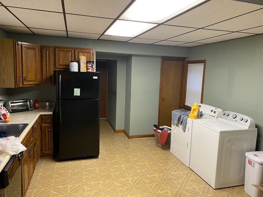 a kitchen with a refrigerator and washer