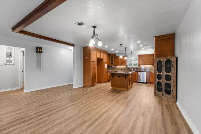 a open kitchen with stainless steel appliances kitchen island granite countertop a sink and cabinets