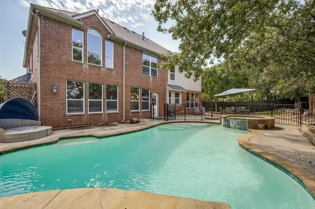 a view of an house with backyard space and sitting area