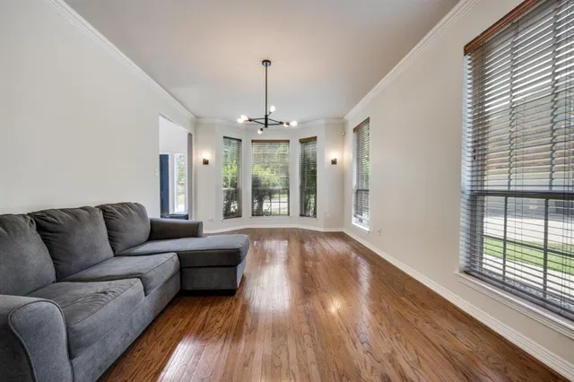 a living room with furniture and a chandelier