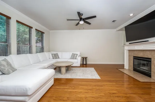 a living room with furniture flat screen tv and a fireplace