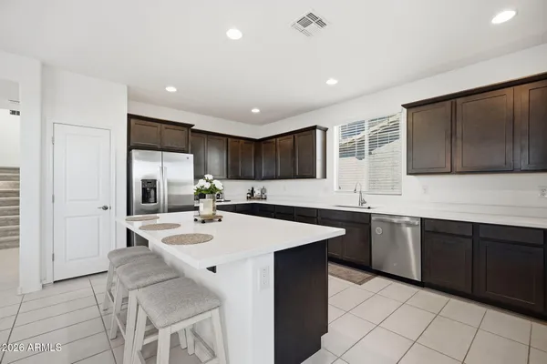 a kitchen with sink cabinets and stainless steel appliances