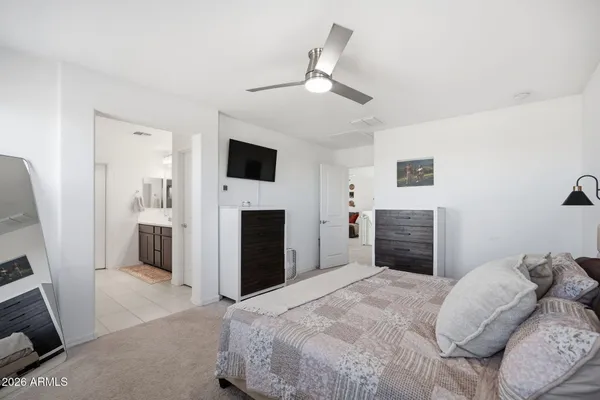 a spacious bedroom with a bed and a fireplace