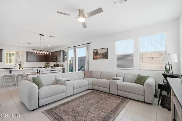 a living room with furniture ceiling fan and a rug