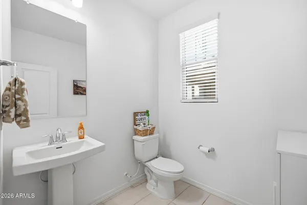 a bathroom with a sink toilet and a mirror
