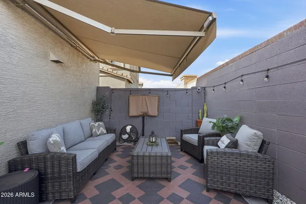 a patio with patio couch and a potted plant