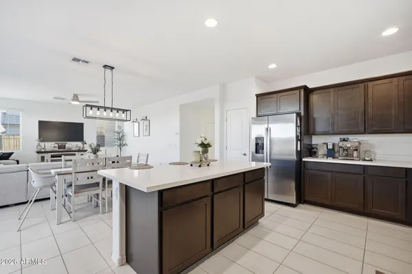 a kitchen with stainless steel appliances kitchen island granite countertop a sink counter space and cabinets