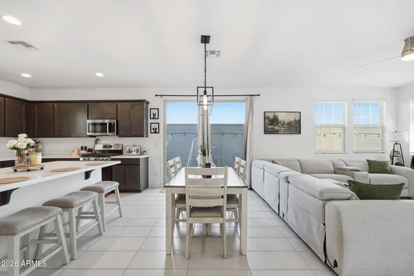 a living room with furniture kitchen and a chandelier