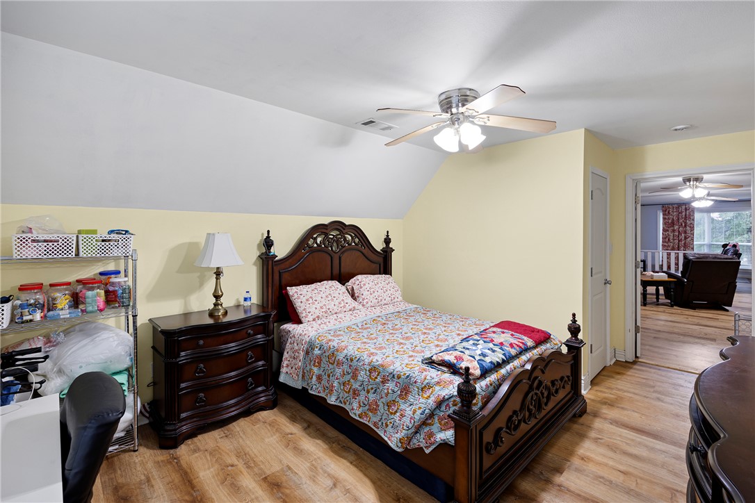 751 Walthall Road Russellville, AR 72802 - Photo 47 of 60 Room with wood-finish flooring, a ceiling fan with integrated lighting, and a white paneled door