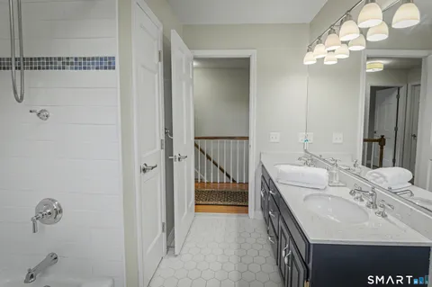 a en suite bathroom with a sink and a mirror