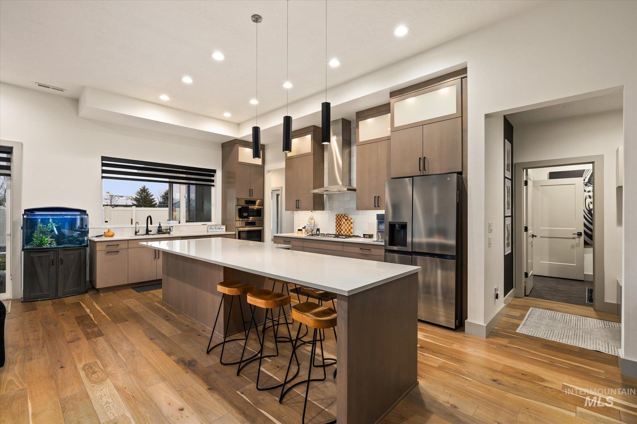 2250 South Steichen Way Meridian, ID 83642 - Photo 12 of 40 Kitchen with a kitchen bar, modern cabinets, stainless steel appliances, hanging light fixtures, and a center island
