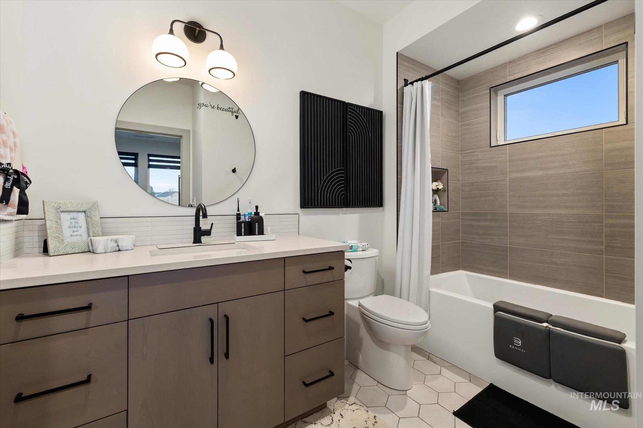 2250 South Steichen Way Meridian, ID 83642 - Photo 19 of 40 Bathroom with vanity, shower / bath combination with curtain, and light tile patterned floors