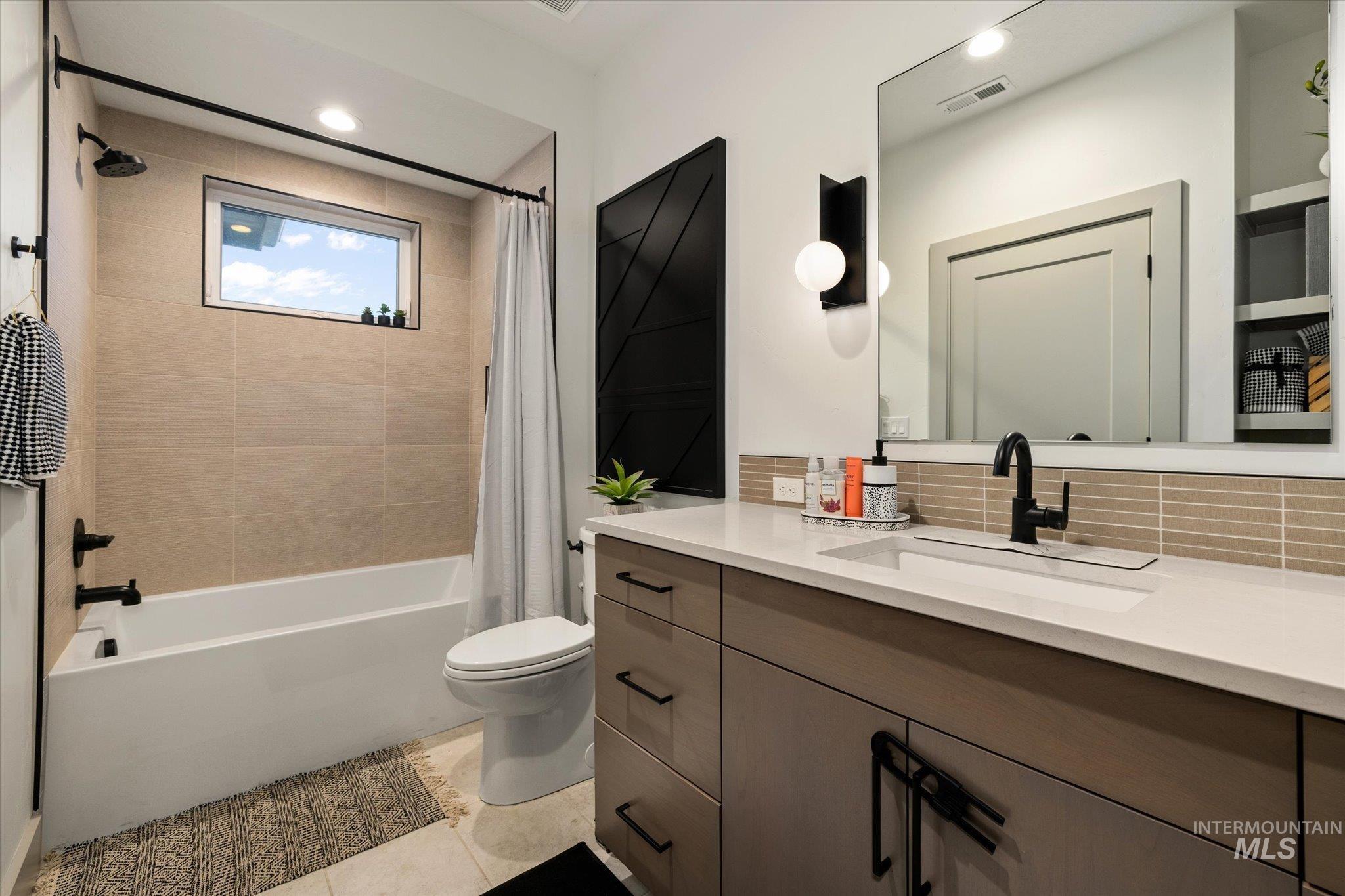 2250 South Steichen Way Meridian, ID 83642 - Photo 23 of 40 Bathroom with vanity, shower / bath combo, backsplash, and recessed lighting